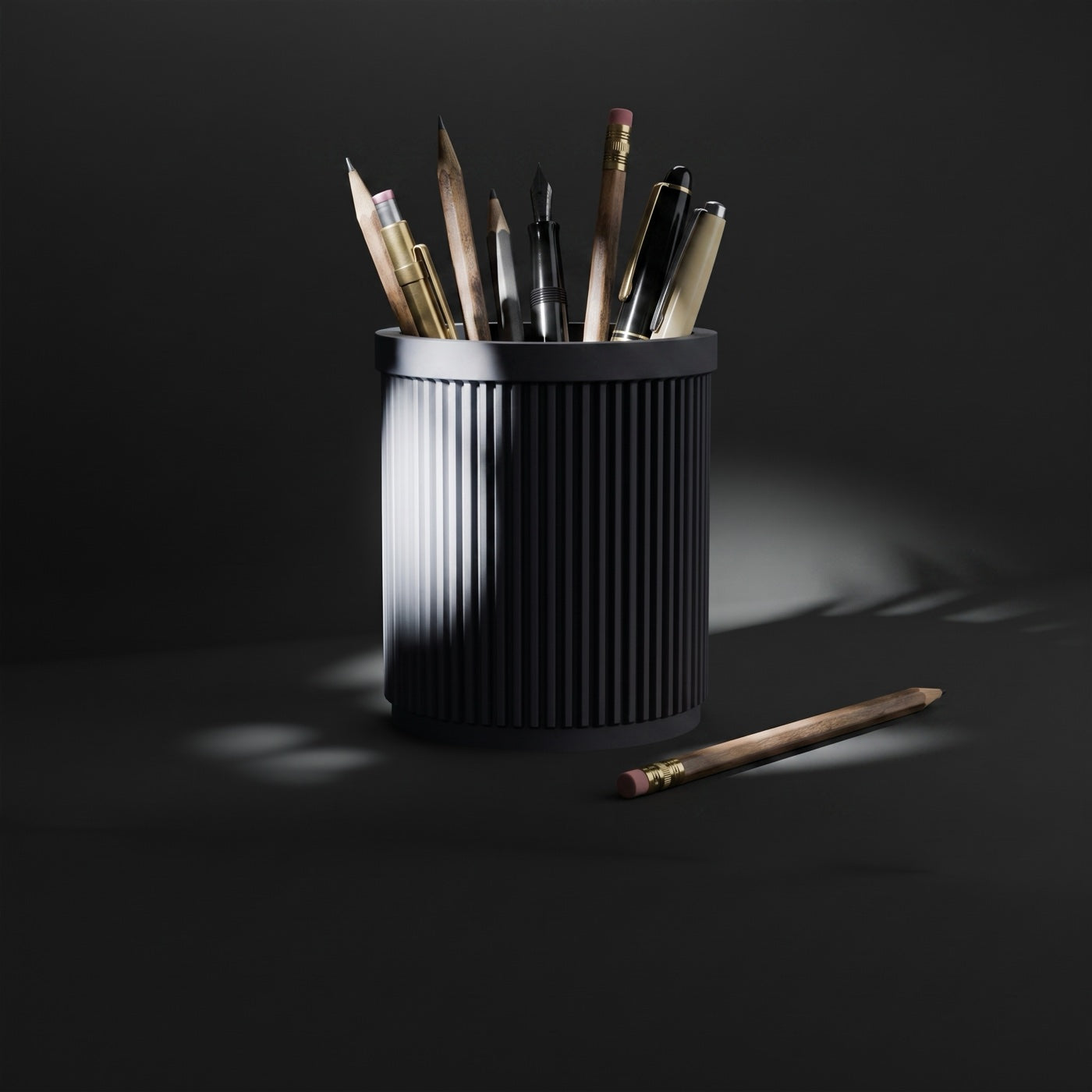 Ribbed pen pot full of pens