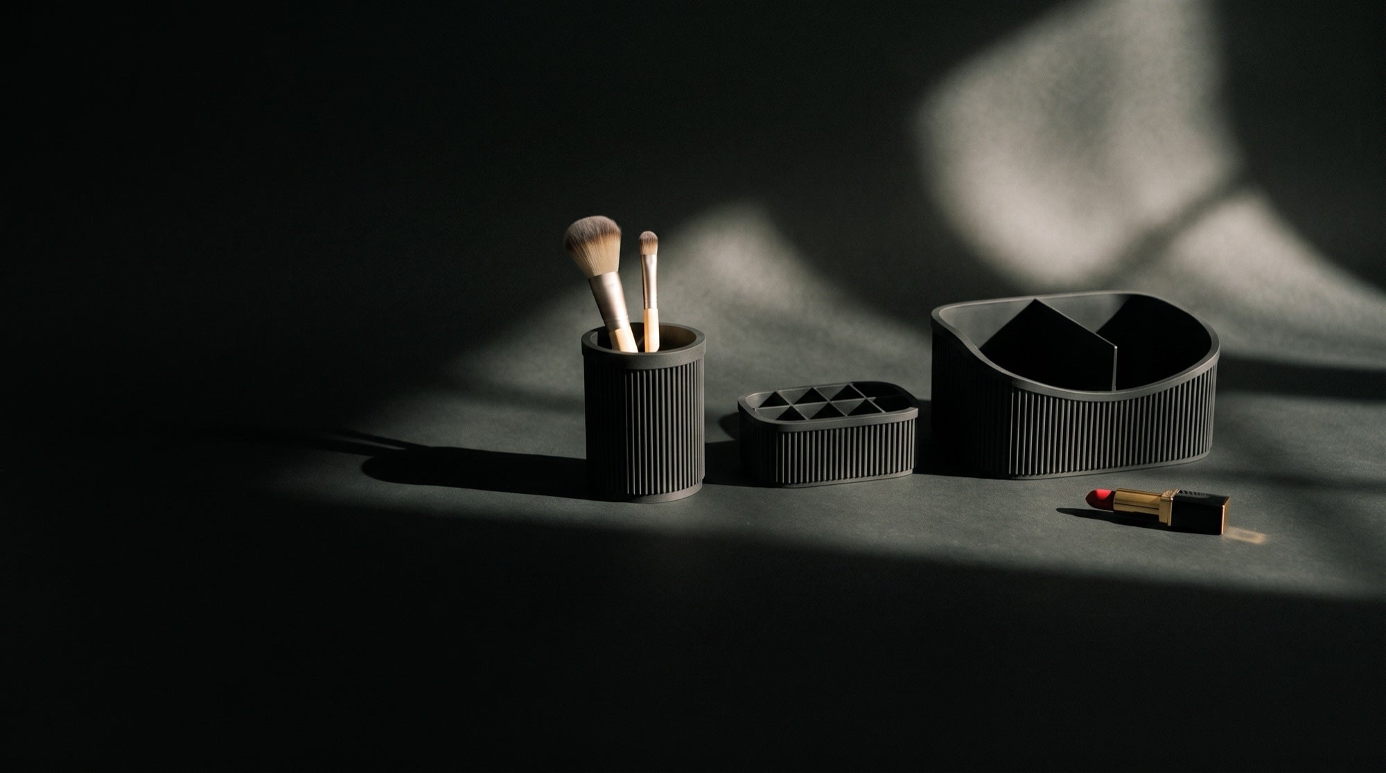 The three piece vanity set in black: caddy, brush cup and lipstick holder